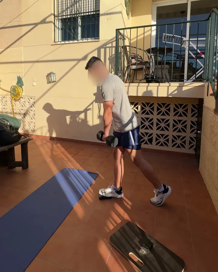 Cliente entrenando con mancuernas en el porche de su casa, en Málaga